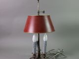 a lamp that has a red shade on top of it