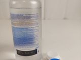 a bottle of water sitting next to a bottle of toothpaste