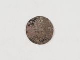 a close up of a coin on a white surface