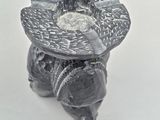 a black and white photo of a candle holder on a table