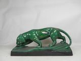 statue of a green tiger on a black base on a white background