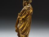 a bronze figure of a man in a robe and hat