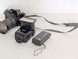 a camera, flash, camera case, and a flash light on a table
