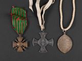 three medals are displayed on a black surface with a ribbon