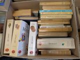 une boîte remplie de livres posés sur le sol