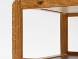 a wooden shelf with a glass door on top of it