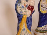 three ceramic figurines of the virgin and child in blue, yellow and white