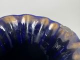 a blue vase that is sitting on a table