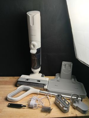 a picture of a table with a camera, a light, and some other items
