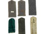 several pieces of cloth are laid out on a white surface