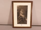 an old photo of a woman sitting on a rock with her hands on her hips