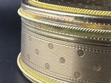 a silver and gold box on a black surface
