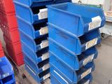 a stack of blue and red bins sitting on top of a pallet