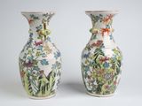 pair of chinese vases decorated with flowers and birds on a white background
