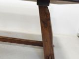 a wooden bench that is sitting in a room