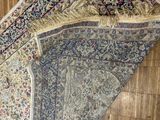 a rug on the floor with a wooden floor in the background