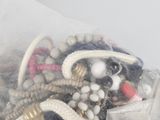 a pile of beads and other items in a plastic bag
