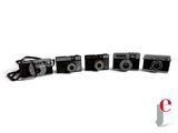 four cameras sitting next to each other on a white surface