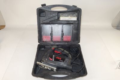 a black case with tools in it on a white surface