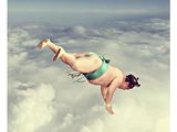 a woman flying through the air in a bikini