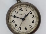 an old pocket watch hanging on the wall