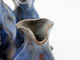 two blue vases that are sitting on a table