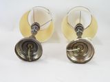 pair of vintage brass lamps with white shades on a white background