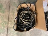 a box full of wires and cords on the ground
