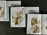 four books that are open on a table
