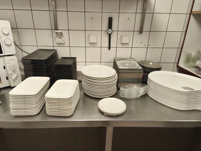 beaucoup d'assiettes et de bols sur le plan de travail de la cuisine
