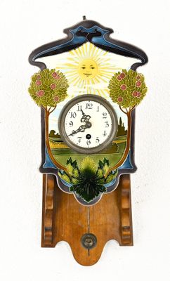 a clock on the wall with a painting on it