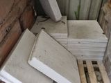 a pile of bricks sitting on the ground next to a building