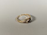 a close up of a gold ring with black and white stones