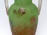 a green vase with a floral design on it