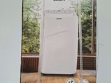 packaging of a white portable air conditioner sitting on top of a wooden floor