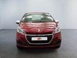 the front view of a red car in a showroom