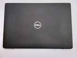 the dell laptop is sitting on a table with a white background