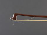 a close up of a violin bow with a string attached to it