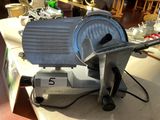 a large slicer sitting on a table in a kitchen