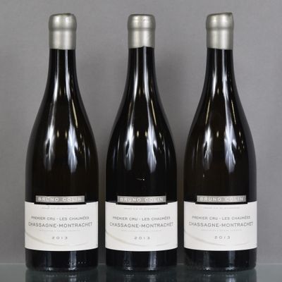 three bottles of wine are lined up on a table