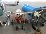 a machine that is sitting on the ground next to other tools