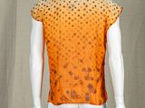 an image of a mannequin wearing an orange and black dotted shirt