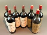 several bottles of wine are lined up on a table