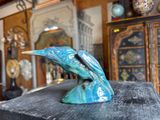 a statue of a bird that is sitting on top of a table