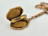 an image of a gold locke with a chain on a white surface