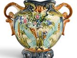 a vase with flowers on it sitting on a stand