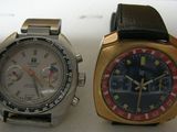 two watches sitting next to each other on a table