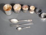 a table with silverware and silver spoons on it