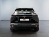 the rear end of a black car parked in a white room
