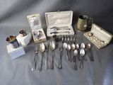 a lot of silver spoons and spoons on a table